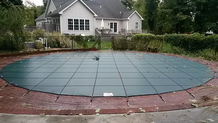 Merlin safety cover fitted over a backyard pool